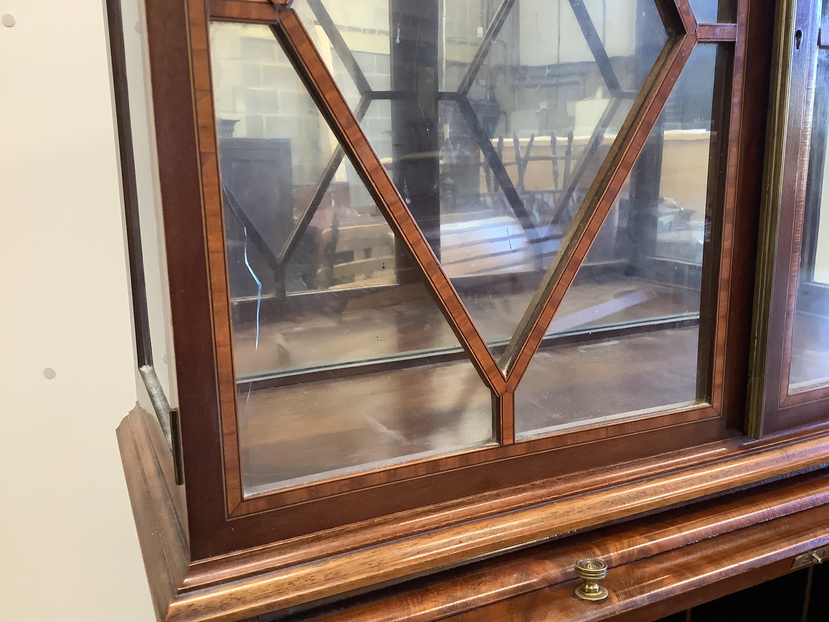 A small Edwardian satinwood banded mahogany cylinder bureau bookcase, width 64cm, depth 47cm, height 151cm